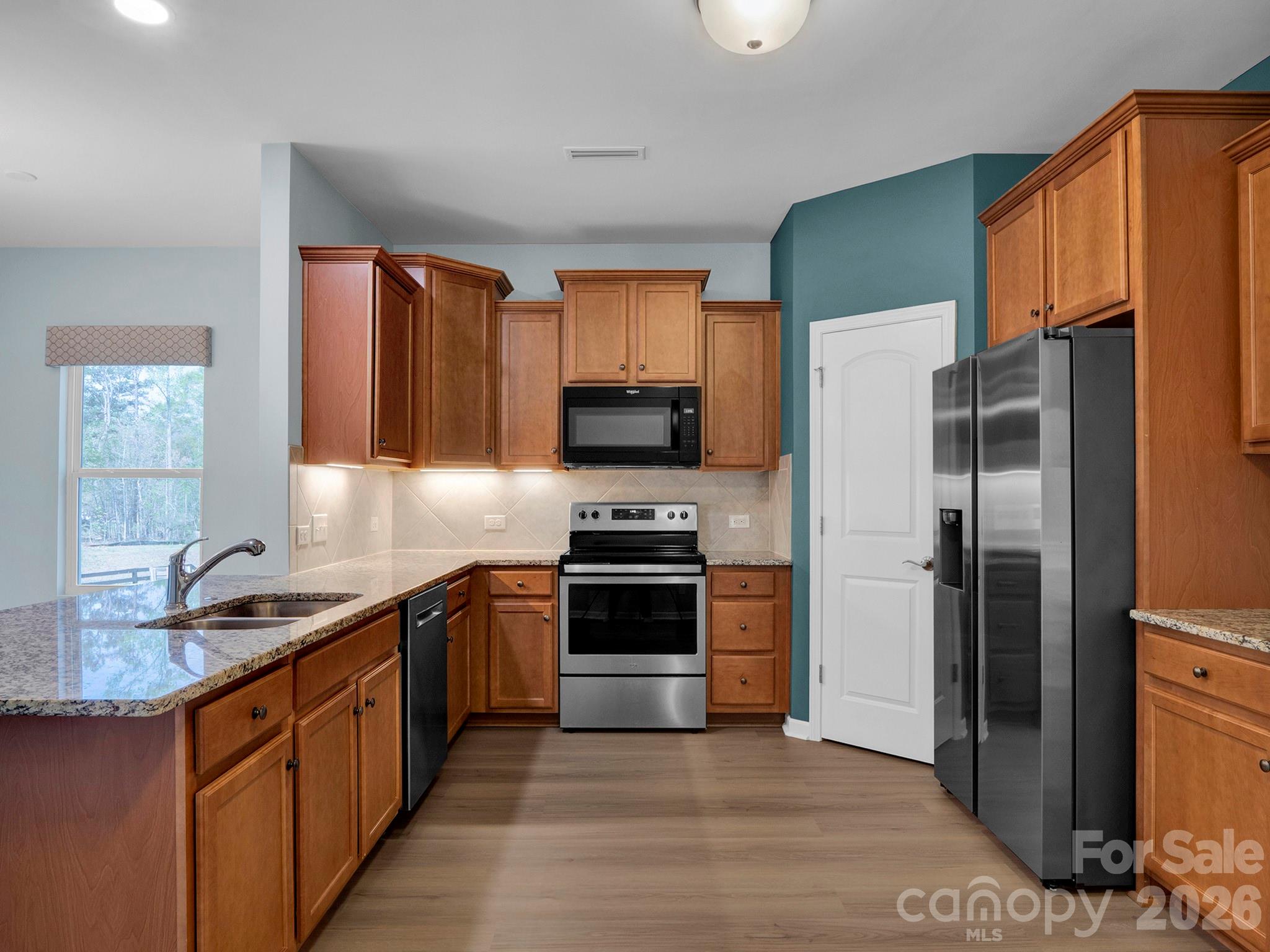 4327 Bent Green Lane Monroe, NC 28112 - Photo 7 of 28 a kitchen with stainless steel appliances granite countertop a refrigerator stove and oven