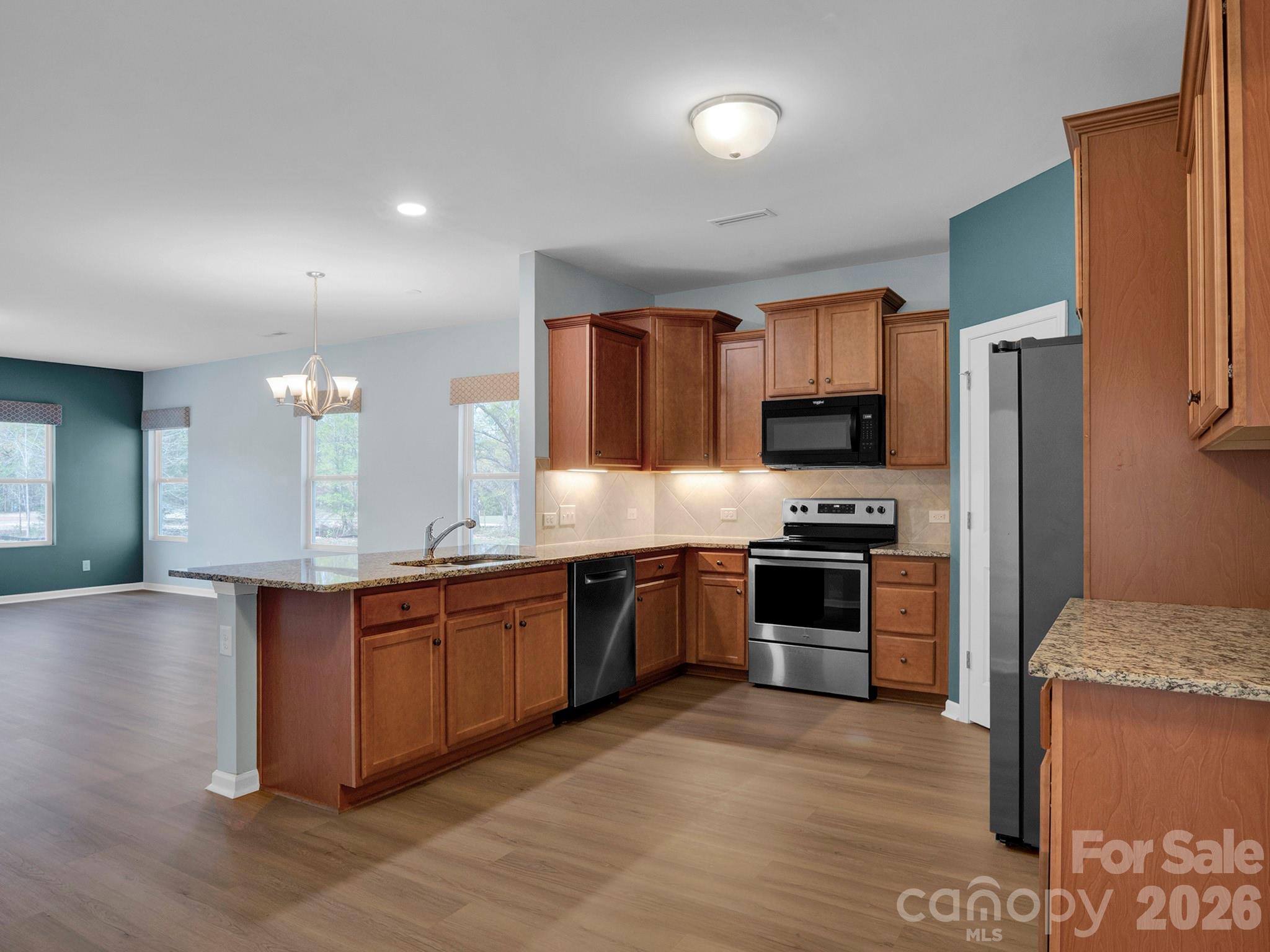 4327 Bent Green Lane Monroe, NC 28112 - Photo 8 of 28 a large kitchen with stainless steel appliances granite countertop a stove refrigerator sink and microwave
