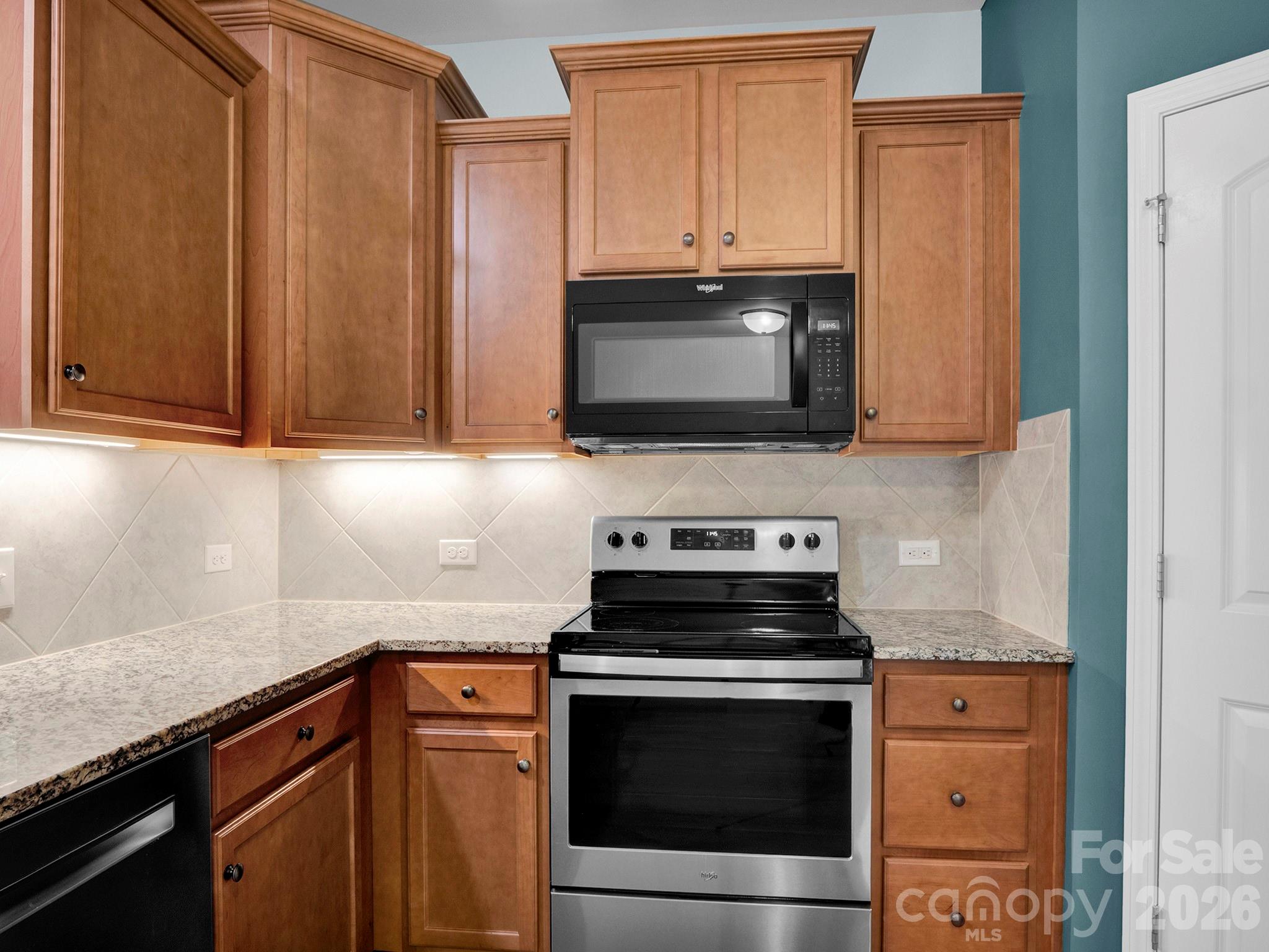 4327 Bent Green Lane Monroe, NC 28112 - Photo 9 of 28 a kitchen with granite countertop cabinets stainless steel appliances and wooden cabinets