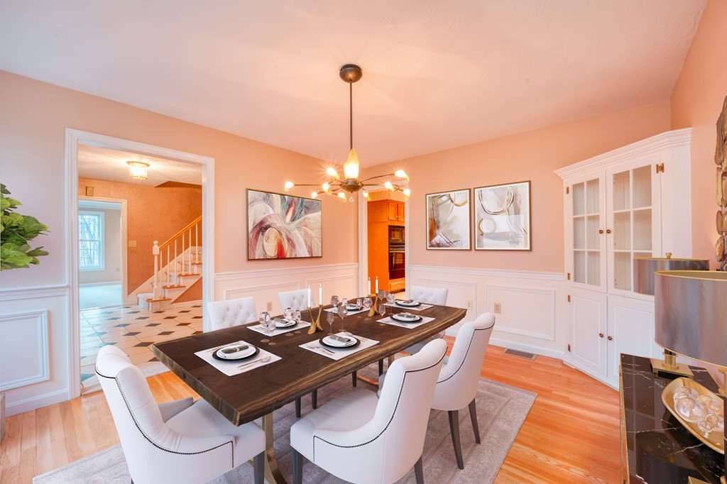 873 Depot Road Boxborough, MA 01719 - Photo 11 of 33 a view of a dining room with furniture a chandelier and wooden floor