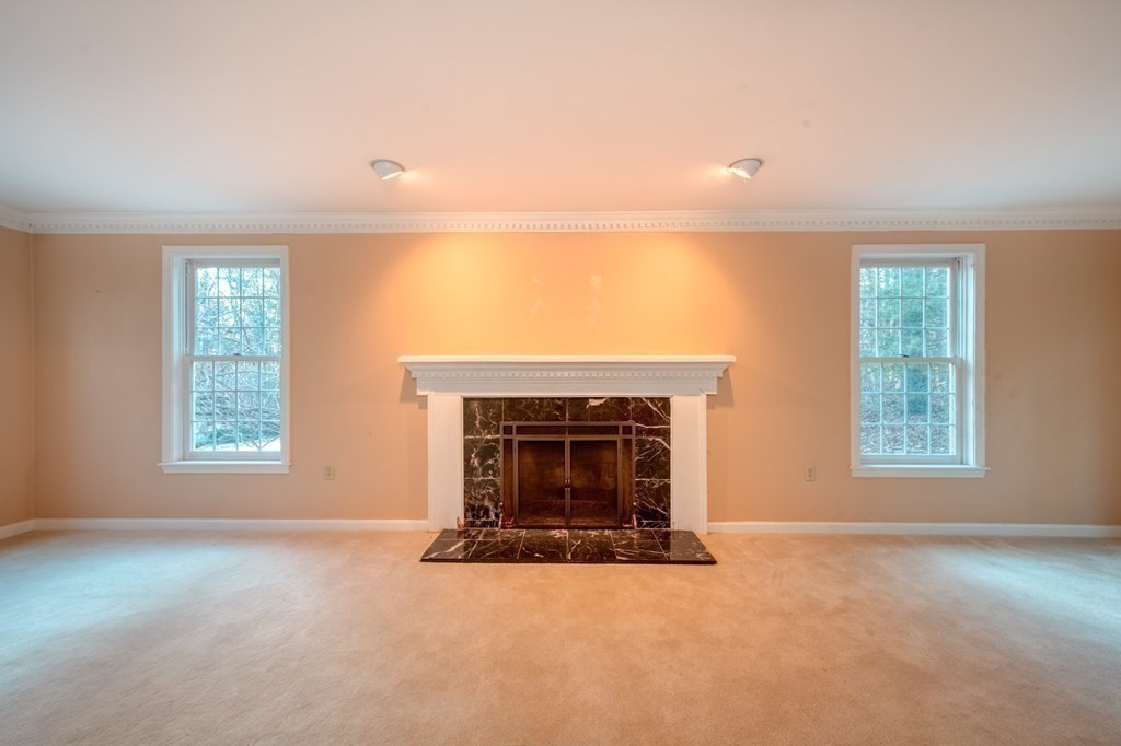 873 Depot Road Boxborough, MA 01719 - Photo 14 of 33 an empty room with furniture and a fireplace