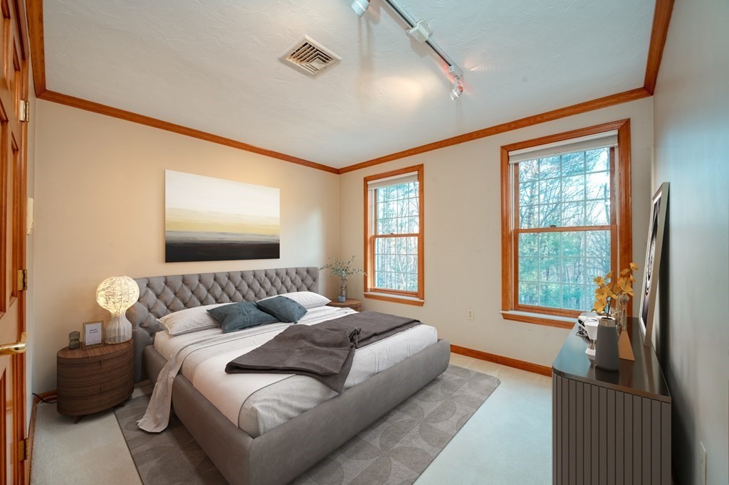 873 Depot Road Boxborough, MA 01719 - Photo 21 of 33 a bedroom with furniture and a flat screen tv