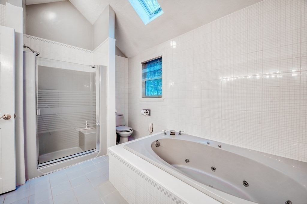 873 Depot Road Boxborough, MA 01719 - Photo 25 of 33 a bathroom with a bathtub and a shower