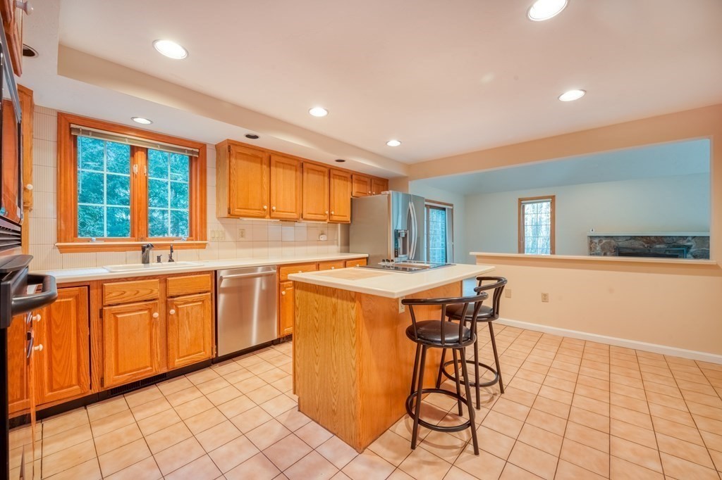 873 Depot Road Boxborough, MA 01719 - Photo 7 of 33 a kitchen with stainless steel appliances granite countertop a sink and a stove top oven