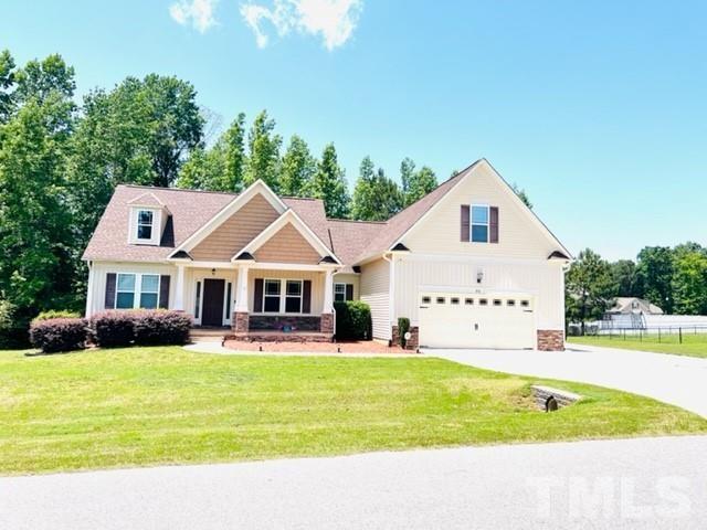 70 Breadnut Drive Smithfield, NC 27577 - Photo 1 of 19 a view of swimming pool with lawn chairs and plants