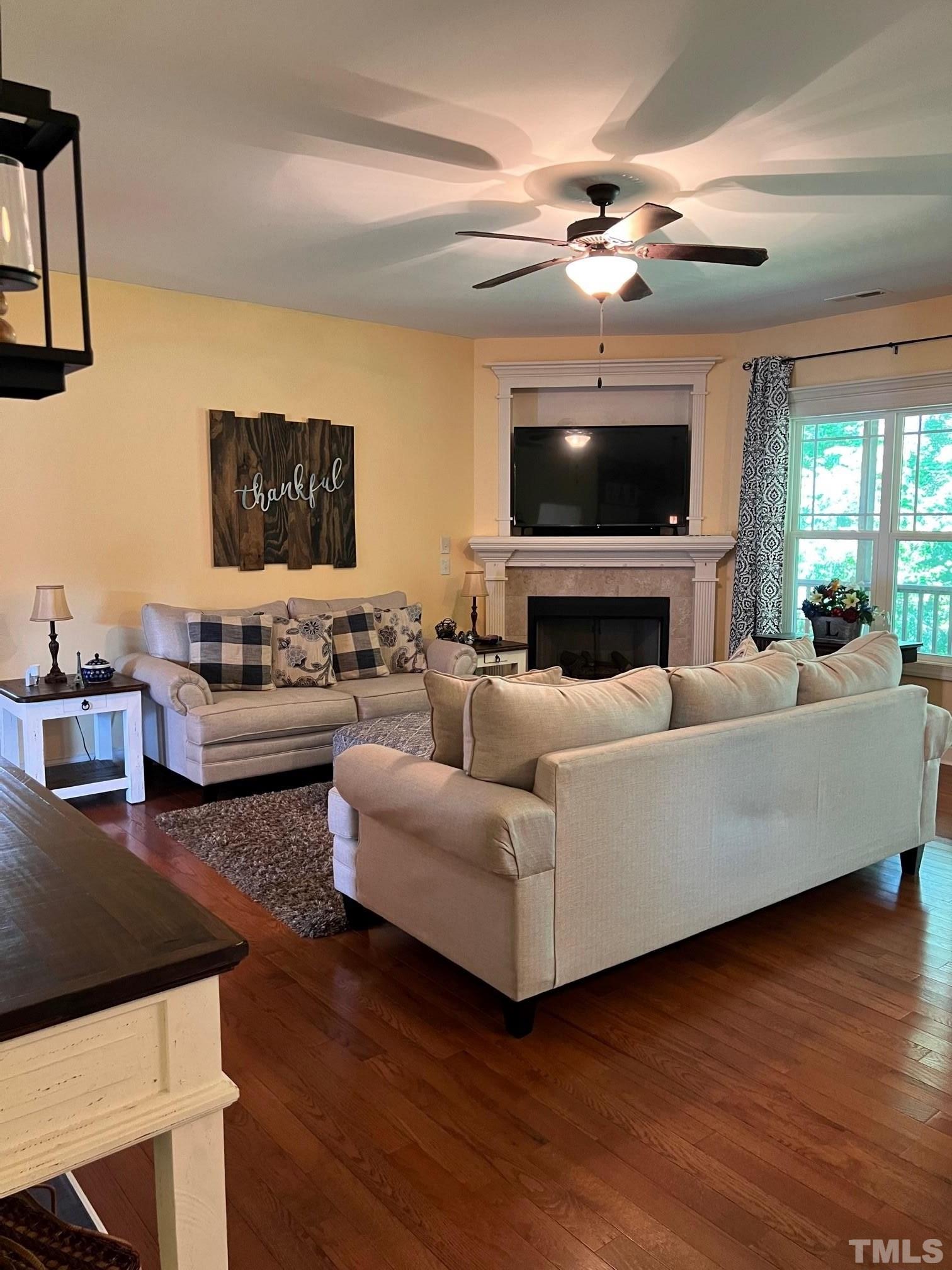 70 Breadnut Drive Smithfield, NC 27577 - Photo 14 of 19 a living room with furniture flat screen tv and a fireplace