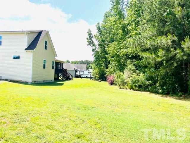 70 Breadnut Drive Smithfield, NC 27577 - Photo 10 of 19 a swimming pool with yard and trees in the background