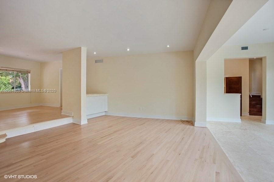 335 Pacific Road Key Biscayne, FL 33149 - Photo 11 of 50 wooden floor in an empty room with a window