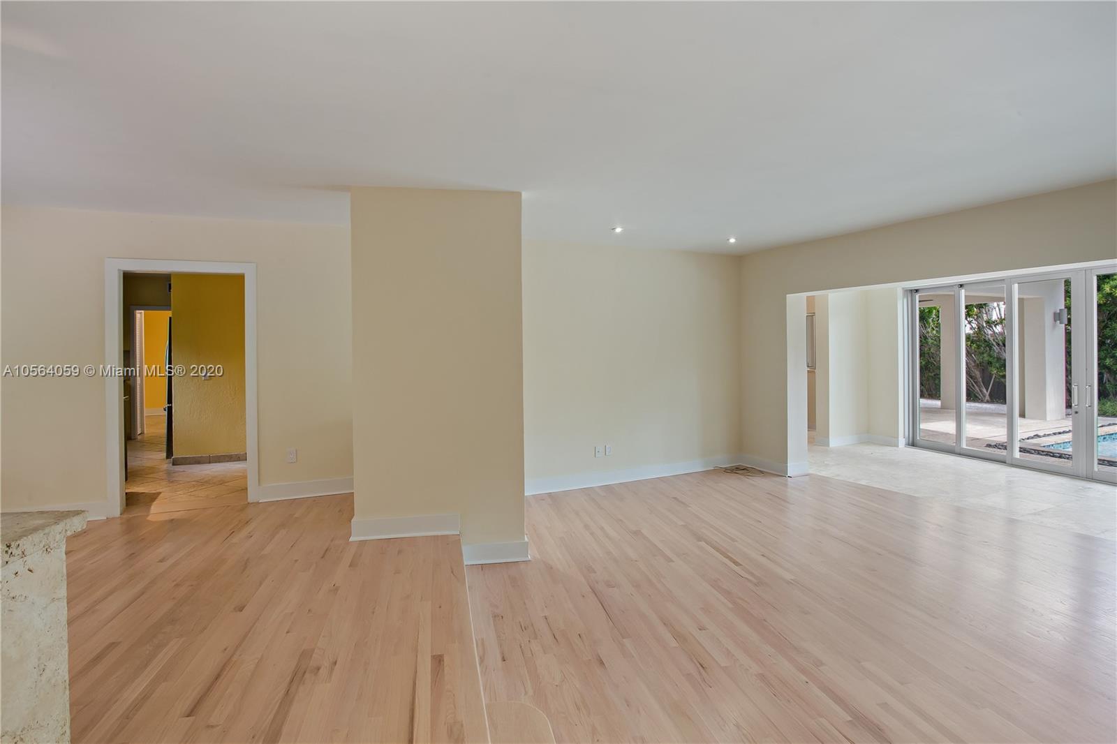 335 Pacific Road Key Biscayne, FL 33149 - Photo 12 of 50 a view of an empty room with wooden floor and a window