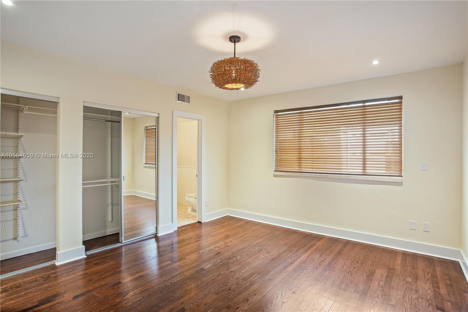 335 Pacific Road Key Biscayne, FL 33149 - Photo 22 of 50 wooden floor in an empty room with a window