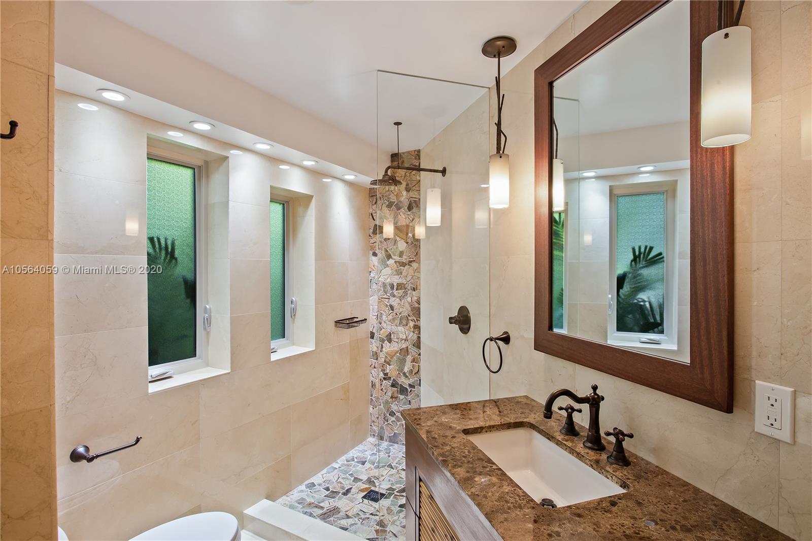 335 Pacific Road Key Biscayne, FL 33149 - Photo 24 of 50 a bathroom with a sink and a mirror
