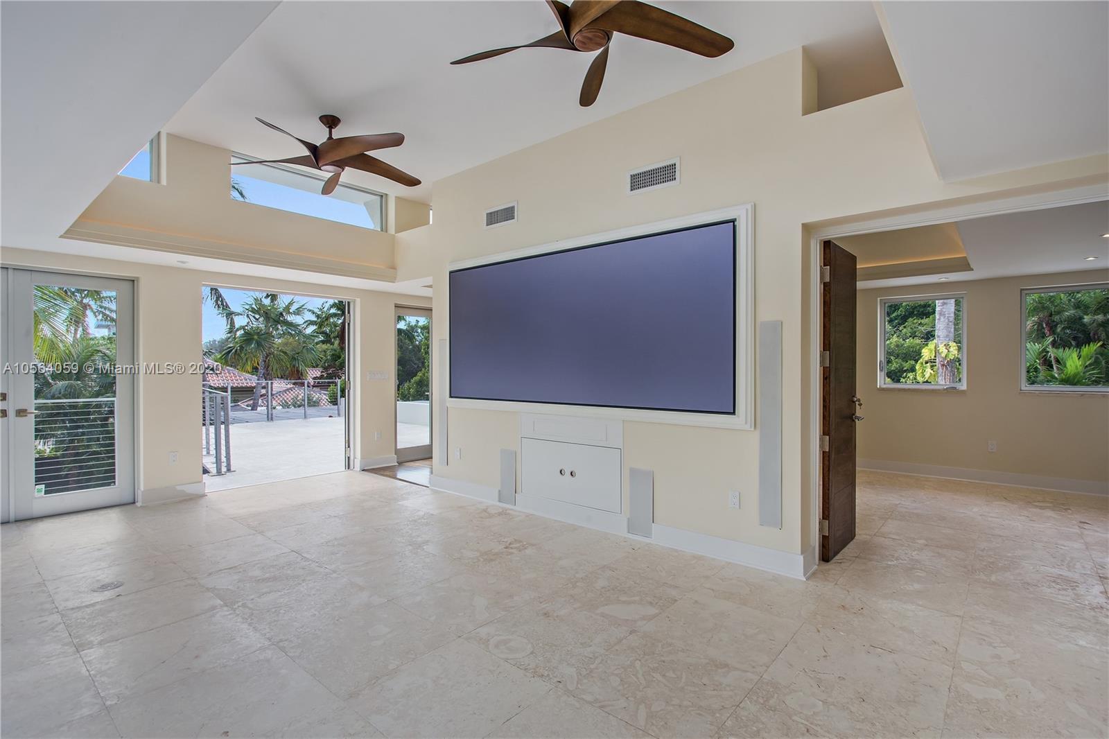 335 Pacific Road Key Biscayne, FL 33149 - Photo 25 of 50 a living room with furniture and a flat screen tv