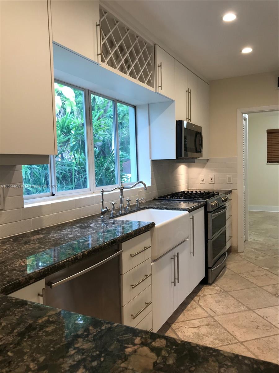 335 Pacific Road Key Biscayne, FL 33149 - Photo 30 of 50 a kitchen with granite countertop a sink and a window