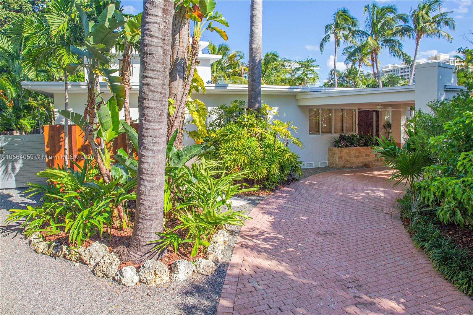 335 Pacific Road Key Biscayne, FL 33149 - Photo 5 of 50 a front view of a house with a garden
