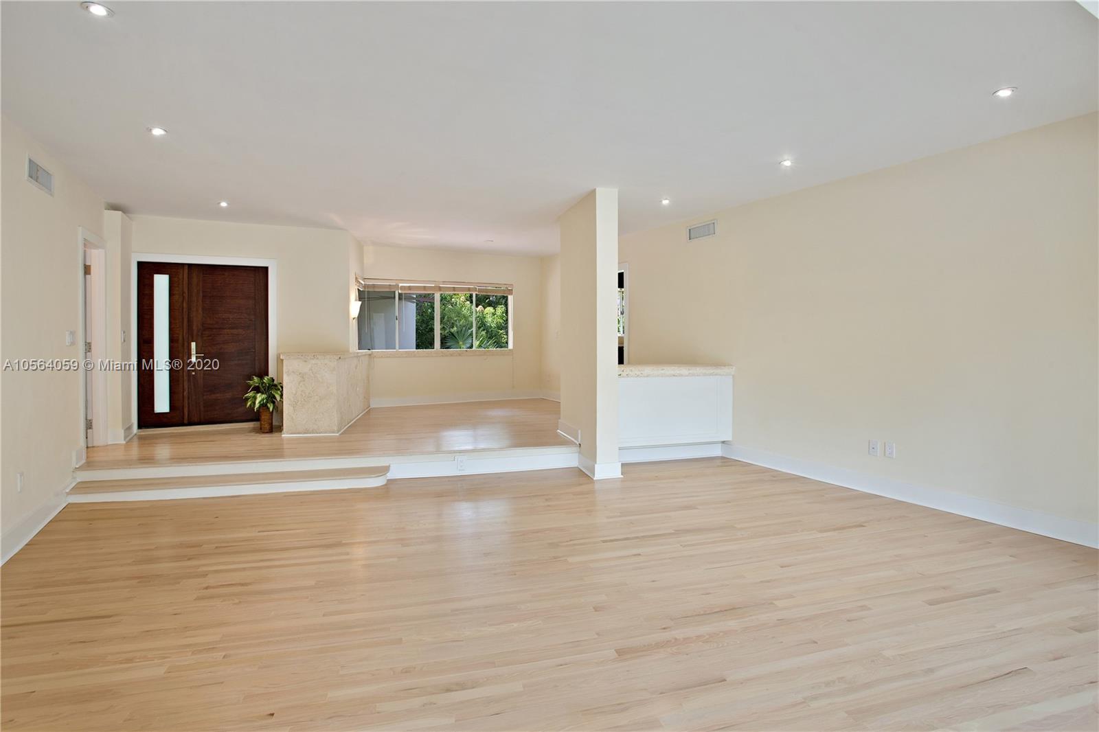 335 Pacific Road Key Biscayne, FL 33149 - Photo 8 of 50 a view of an empty room with wooden floor and a window