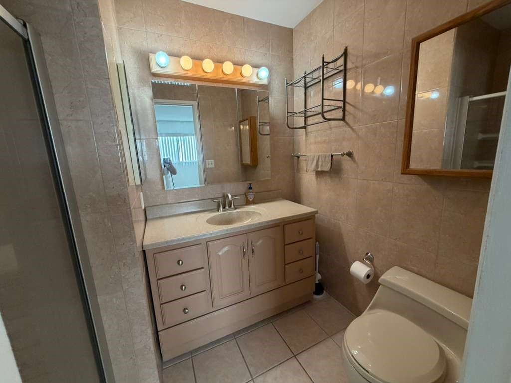330 North Chapel Avenue, Unit 212 Alhambra, CA 91801 - Photo 13 of 25 a bathroom with a toilet sink and mirror