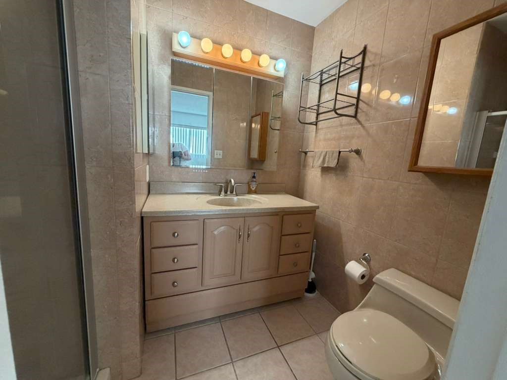 330 North Chapel Avenue, Unit 212 Alhambra, CA 91801 - Photo 22 of 25 a bathroom with a toilet sink and mirror