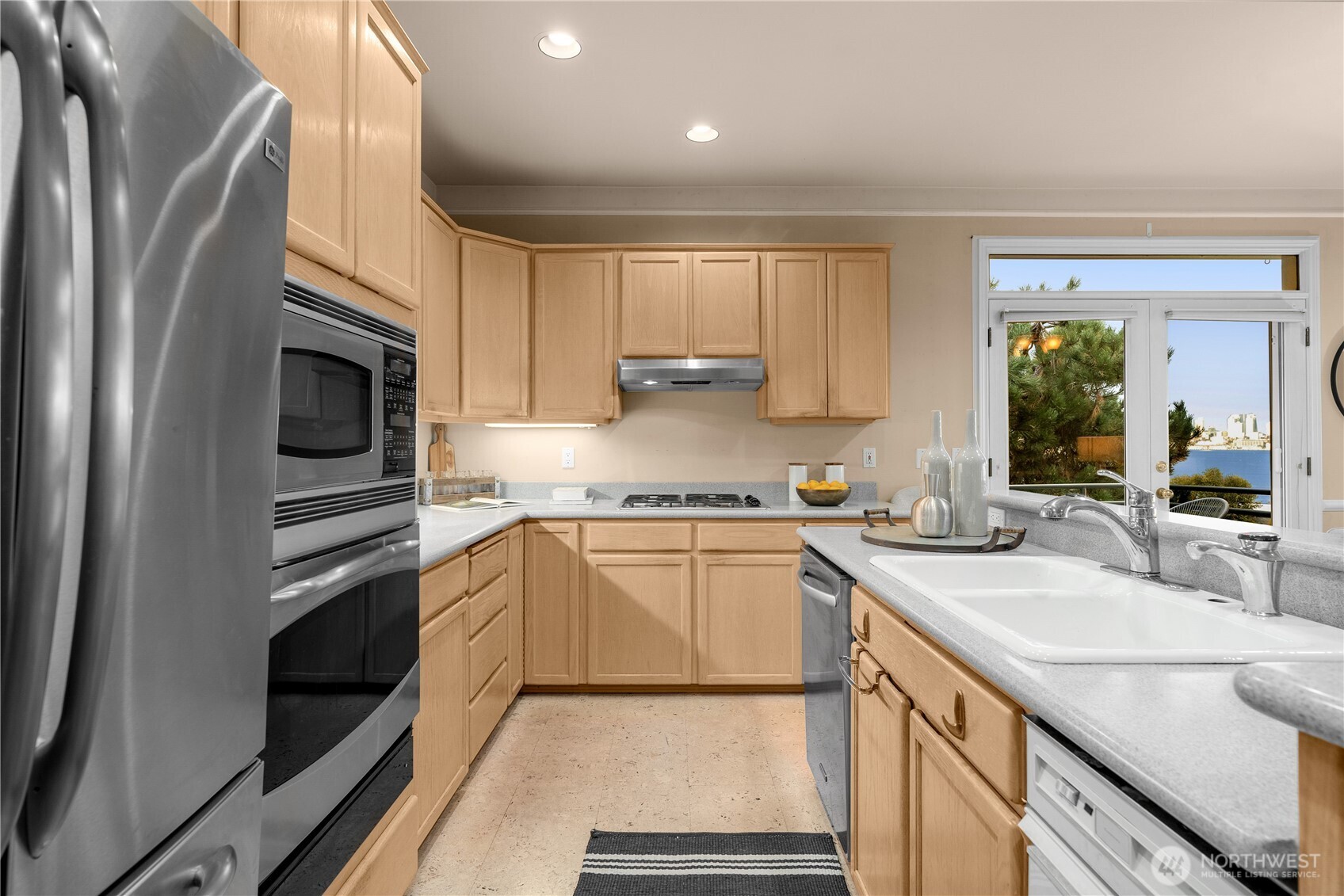2349 Harbor Avenue Southwest, Unit 303 Seattle, WA 98126 - Photo 6 of 36 a kitchen with a sink stove and microwave