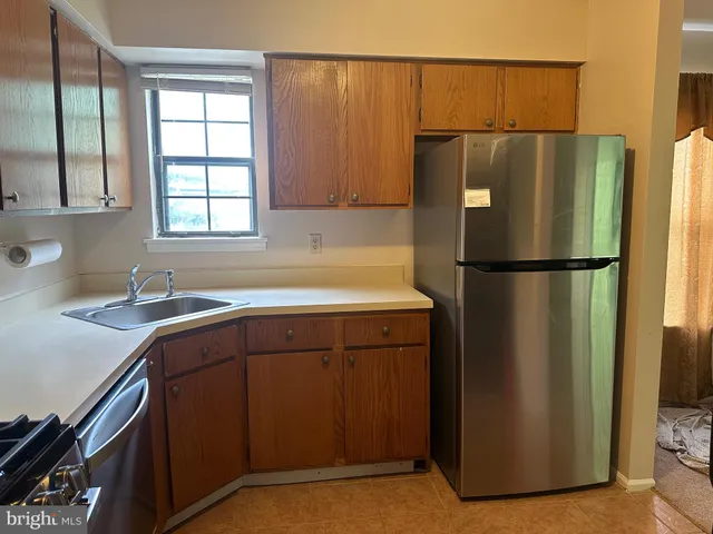 a kitchen with a refrigerator and a sink