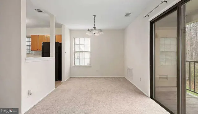 a view of a room with a windows and ceiling fan