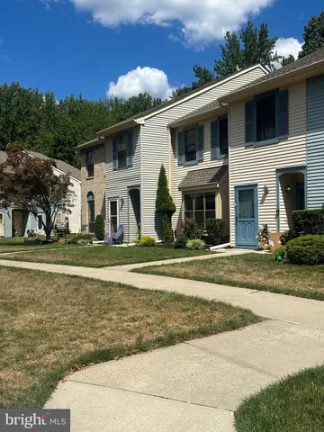 a view of a white house with a swimming pool