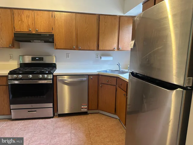 a kitchen with stainless steel appliances a refrigerator and a stove