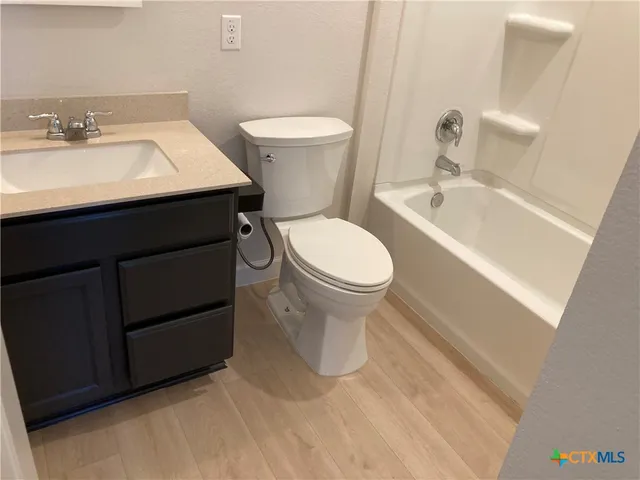 a bathroom with a sink toilet and a mirror