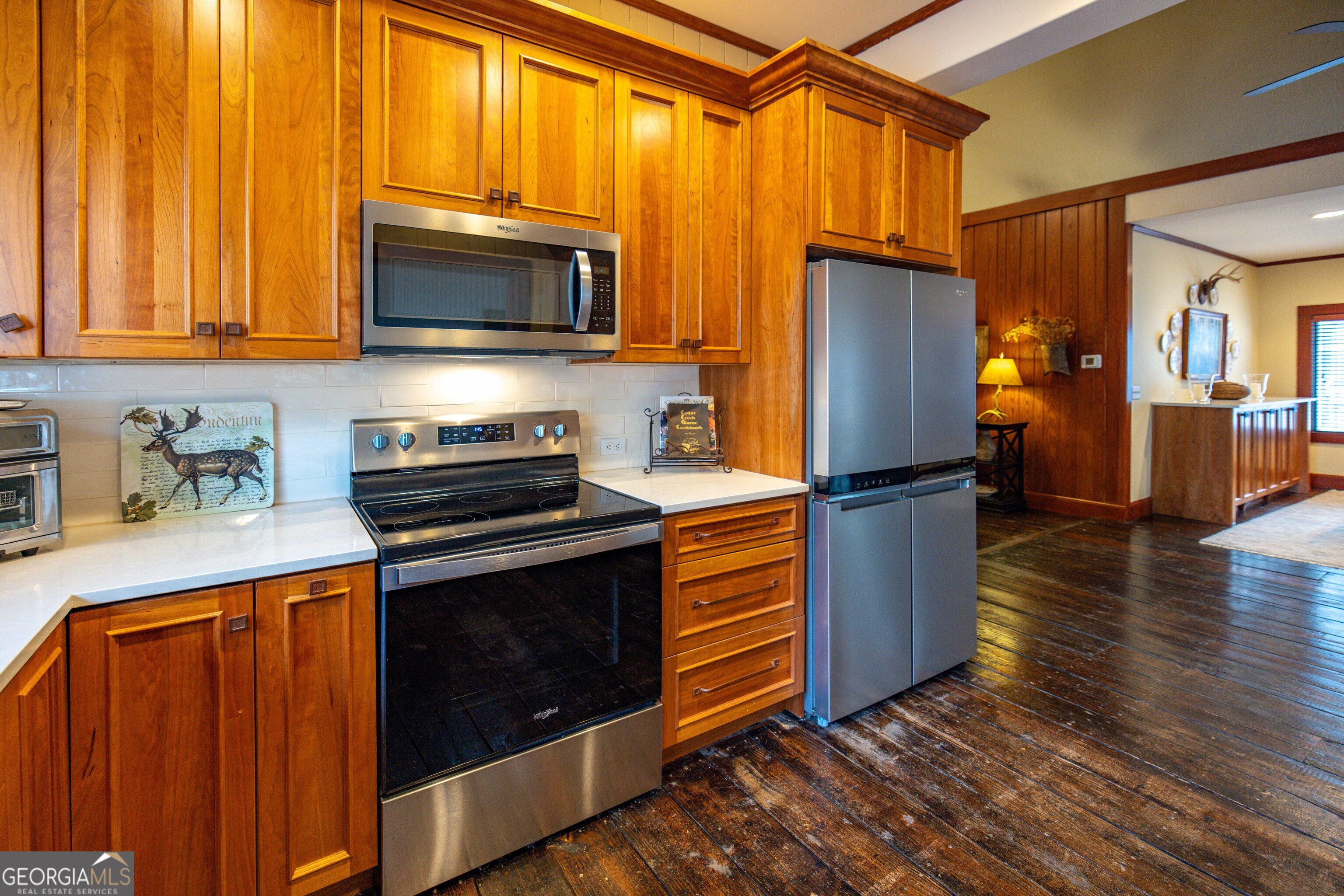279 Mid River Road White Oak, GA 31568 - Photo 12 of 62 a kitchen with granite countertop wooden cabinets stainless steel appliances and a window