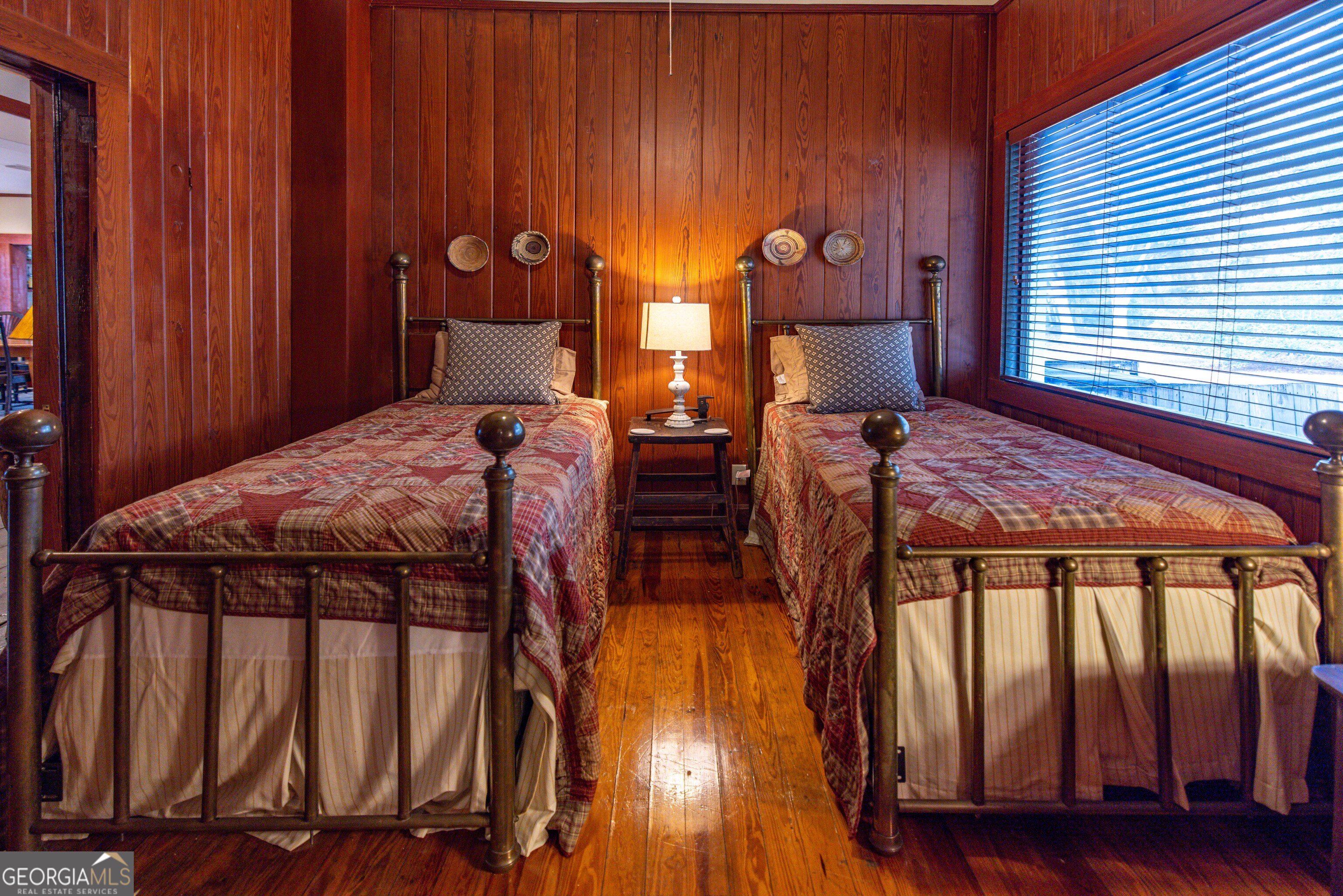 279 Mid River Road White Oak, GA 31568 - Photo 17 of 62 a bedroom with two beds and wooden floor