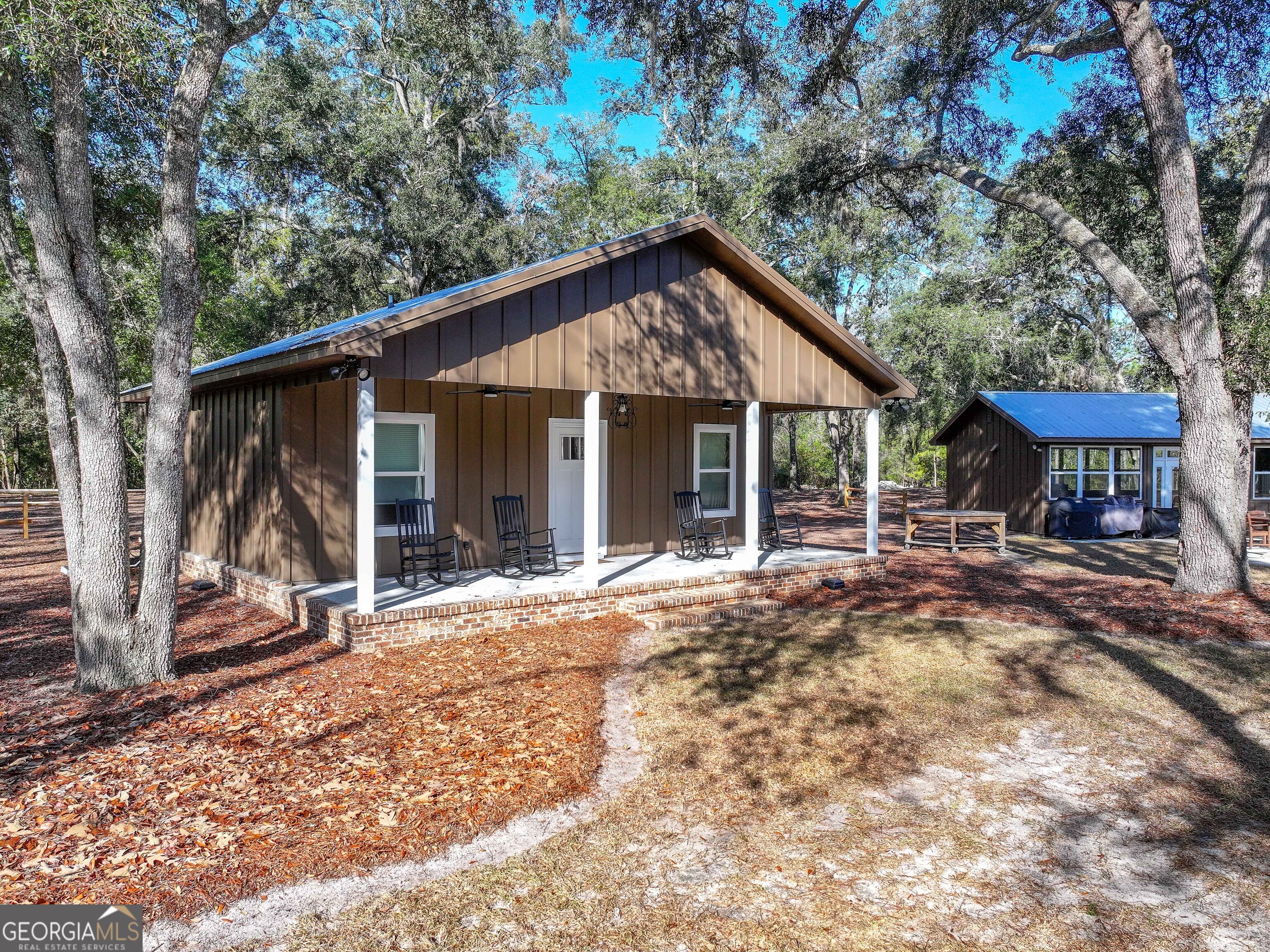 279 Mid River Road White Oak, GA 31568 - Photo 18 of 62 a view of a house with backyard porch and sitting area