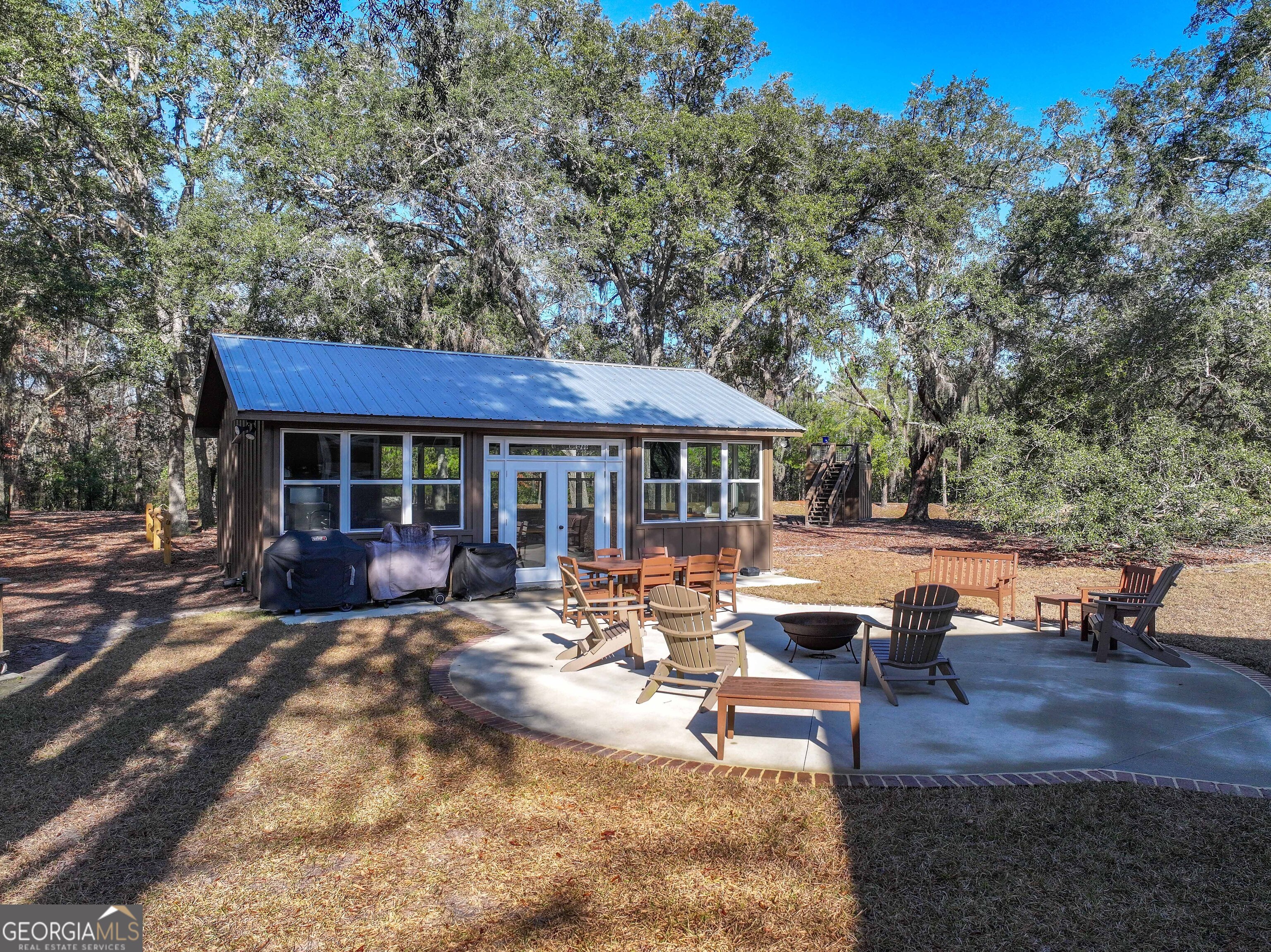 279 Mid River Road White Oak, GA 31568 - Photo 23 of 62 a view of a house with backyard porch and sitting area