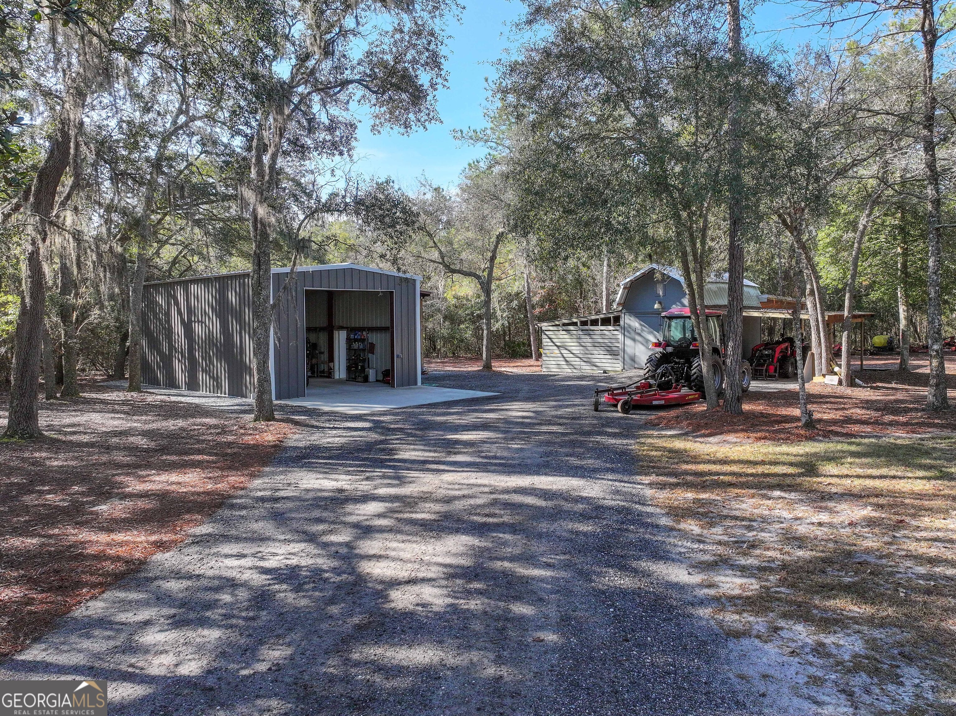 279 Mid River Road White Oak, GA 31568 - Photo 29 of 62 a view of a house with backyard and a tree