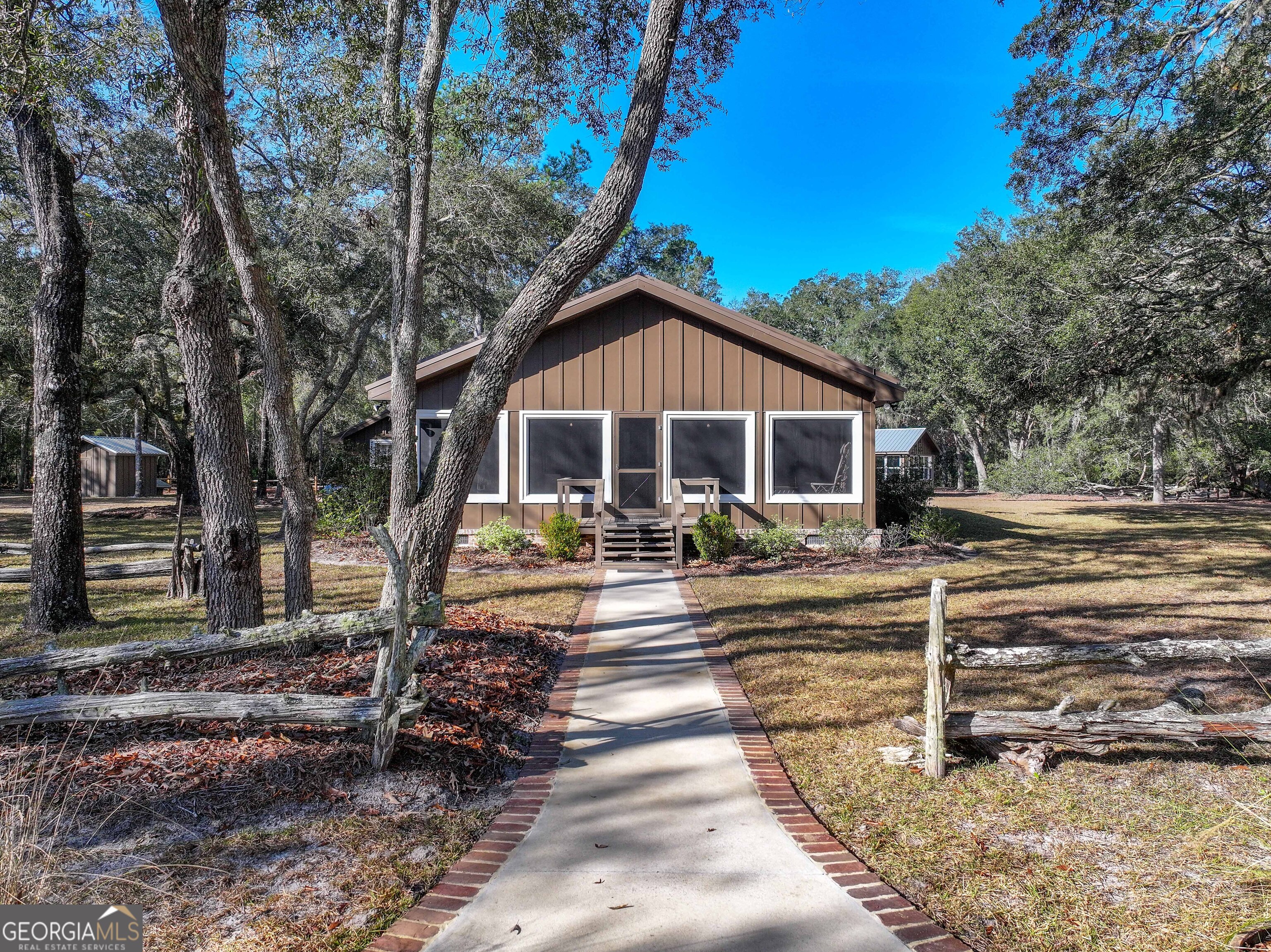 279 Mid River Road White Oak, GA 31568 - Photo 3 of 62 a front view of a house with garden