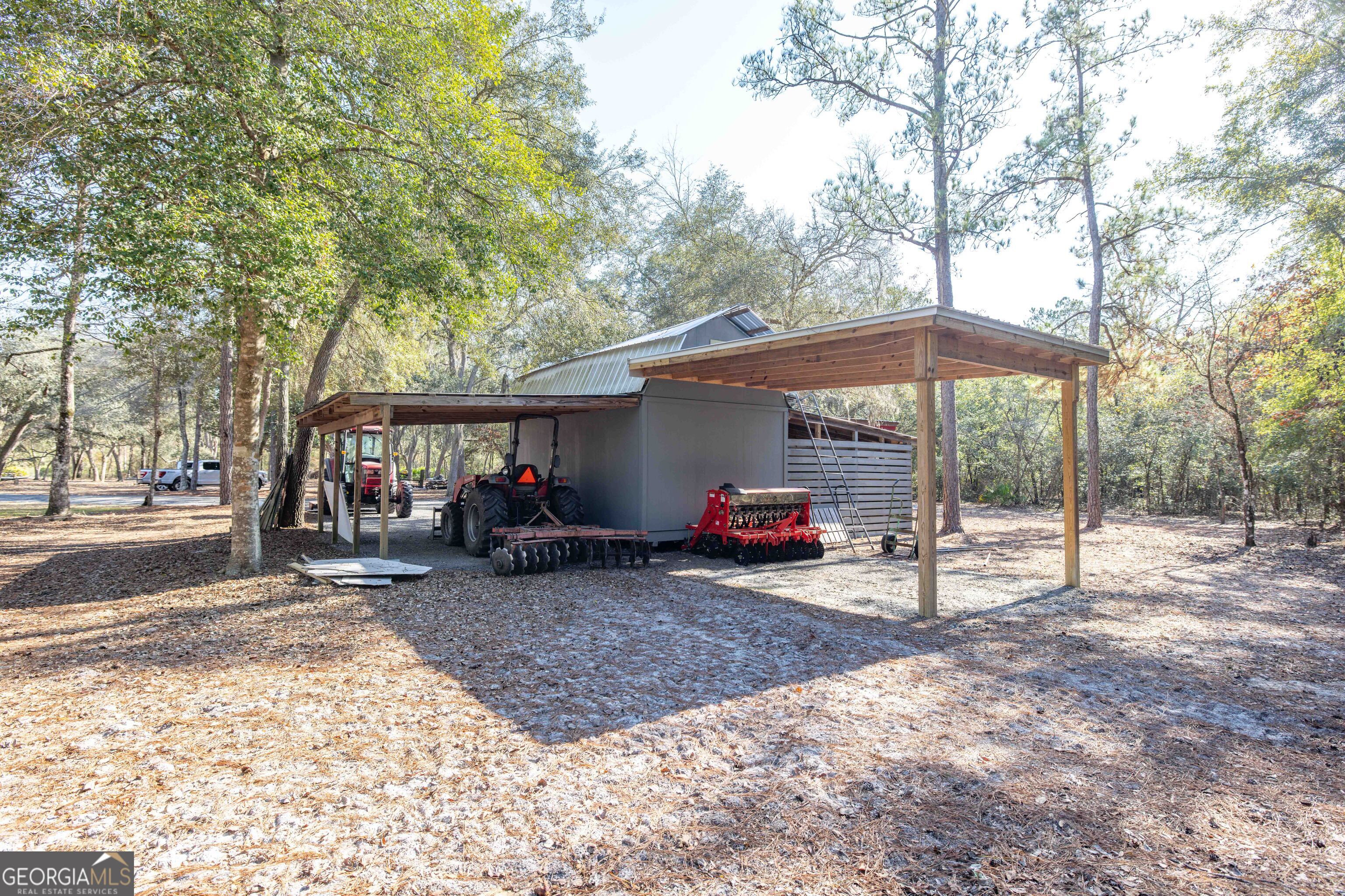 279 Mid River Road White Oak, GA 31568 - Photo 35 of 62 a view of a house with a patio and a yard