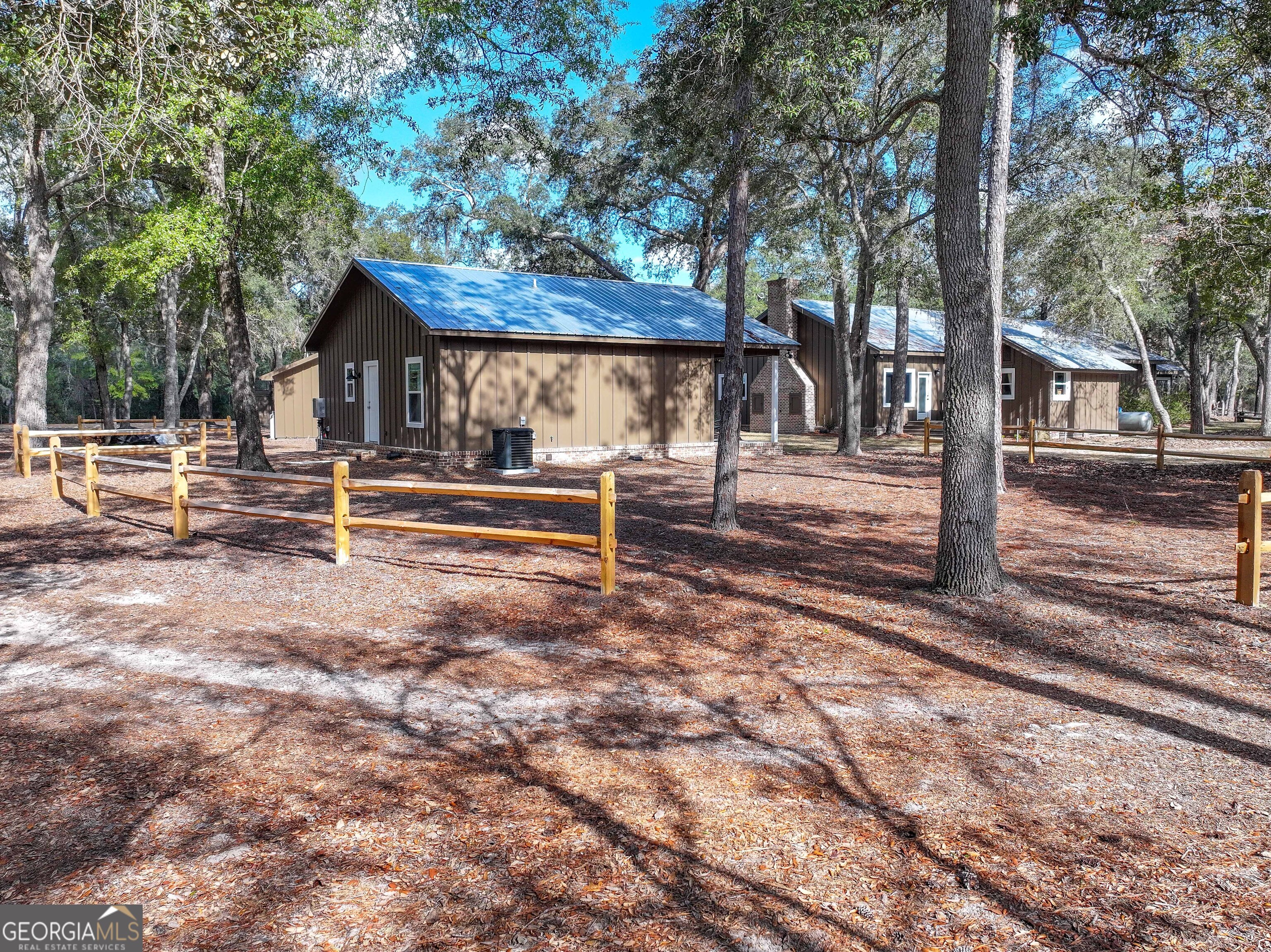 279 Mid River Road White Oak, GA 31568 - Photo 38 of 62 a view of a house with backyard and a tree