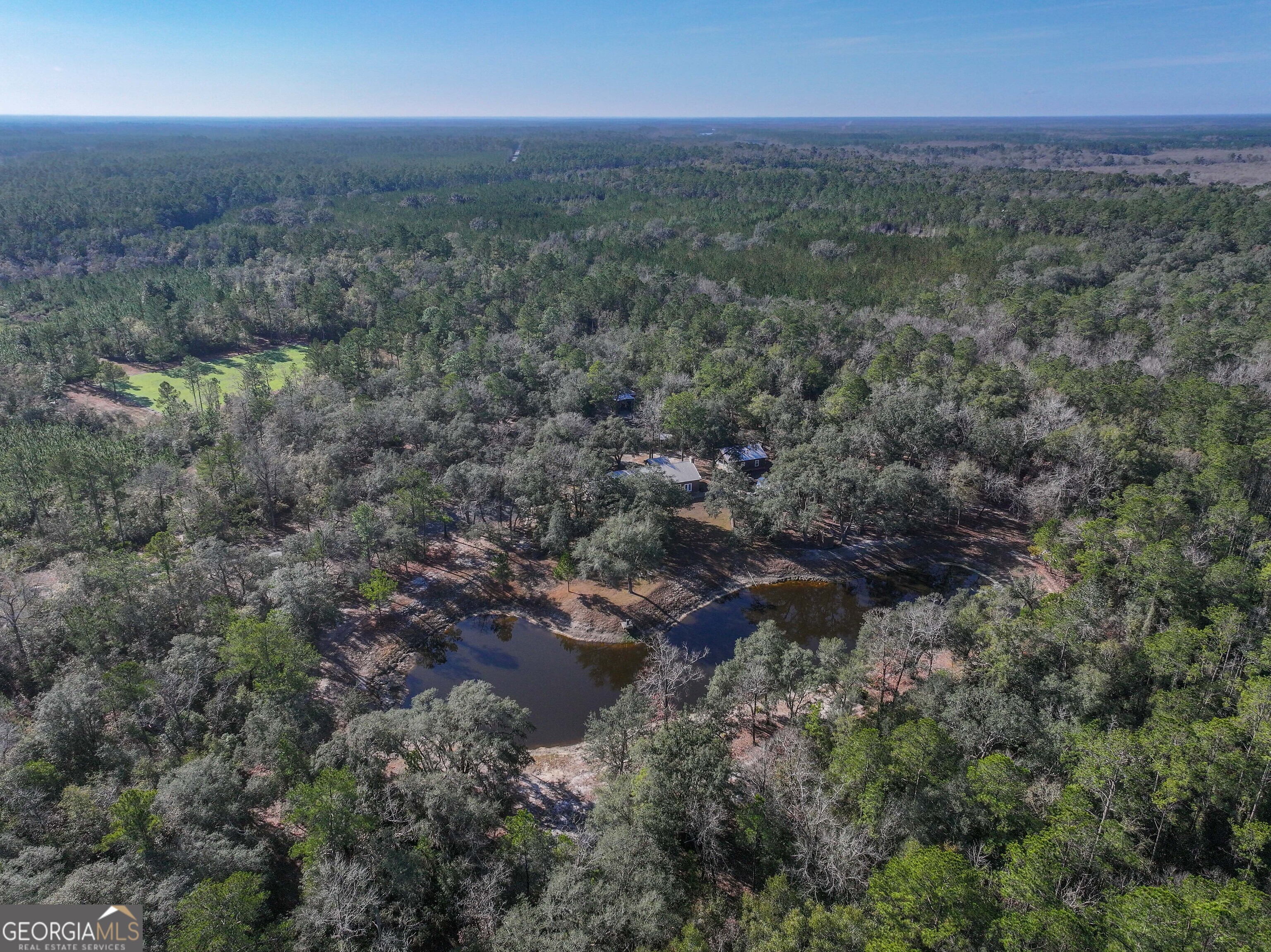 279 Mid River Road White Oak, GA 31568 - Photo 43 of 62 a view of a field with trees in background