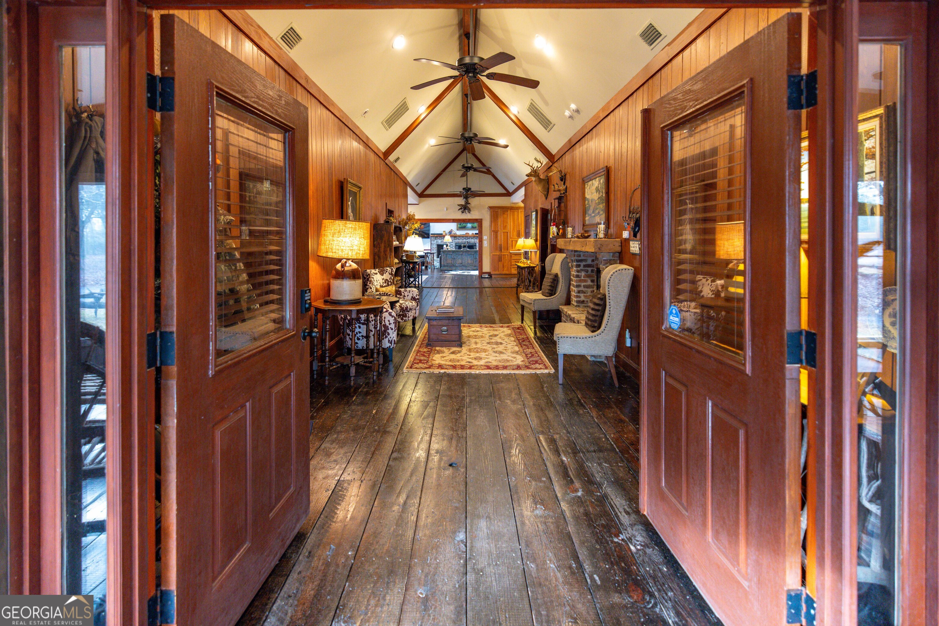 279 Mid River Road White Oak, GA 31568 - Photo 5 of 62 a view of a balcony with furniture and wooden floor