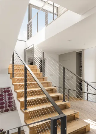 a living room with furniture a piano and a window