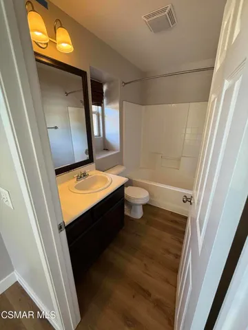 a view of bathroom with a sink and mirror