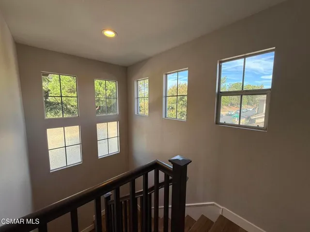 a view of a hallway with windows