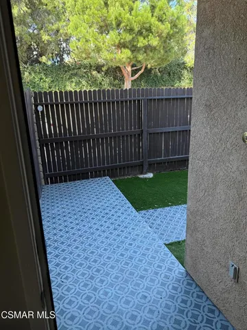 a view of backyard with wooden fence