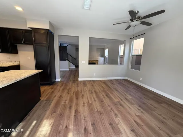 a view of a electric room with wooden floor and a kitchen space with a sink