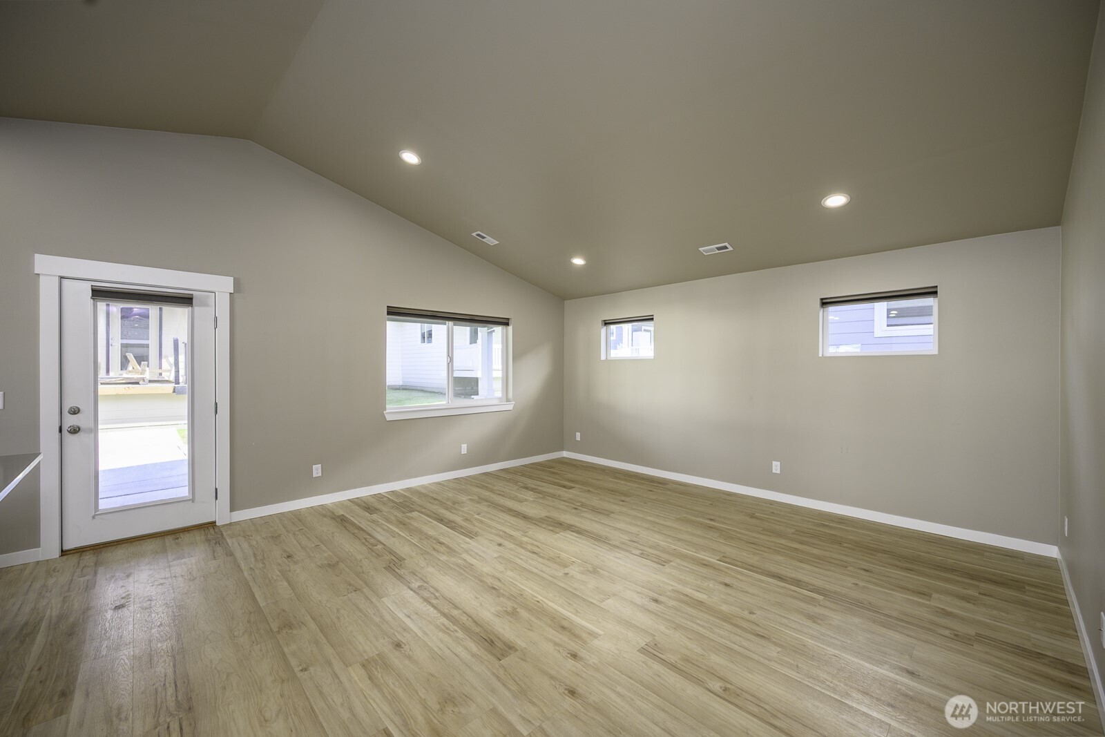 123 9th Avenue, Unit 50 Moses Lake, WA 98837 - Photo 11 of 34 a view of an empty room with wooden floor and a window