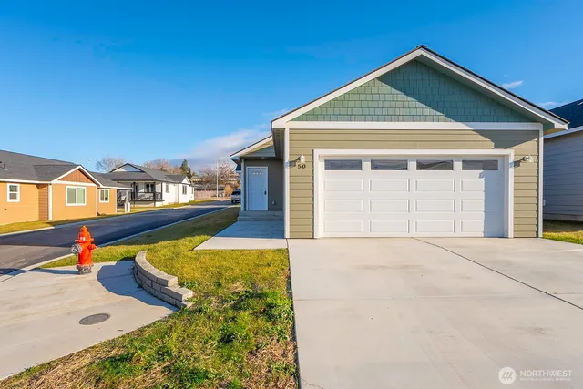 a kitchen with stainless steel appliances granite countertop a refrigerator a sink a stove and oven