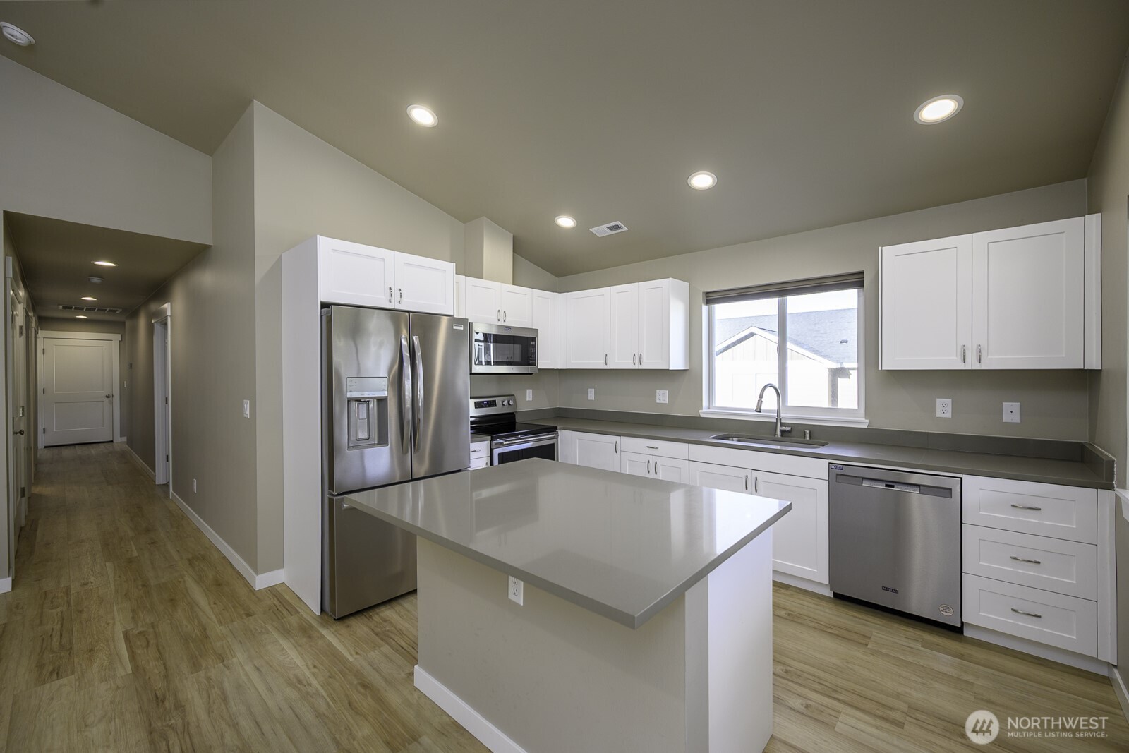 123 9th Avenue, Unit 50 Moses Lake, WA 98837 - Photo 6 of 34 a kitchen with stainless steel appliances granite countertop a sink a stove a refrigerator and cabinets
