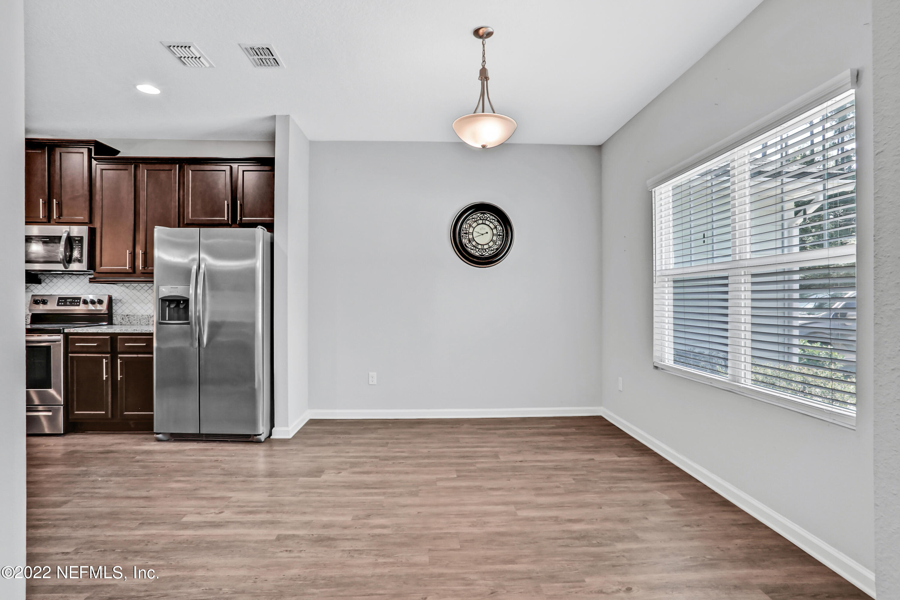 7507 Hilsdale Road Jacksonville, FL 32216 - Photo 11 of 38 a view of a kitchen with stainless steel appliances wooden floor and a window