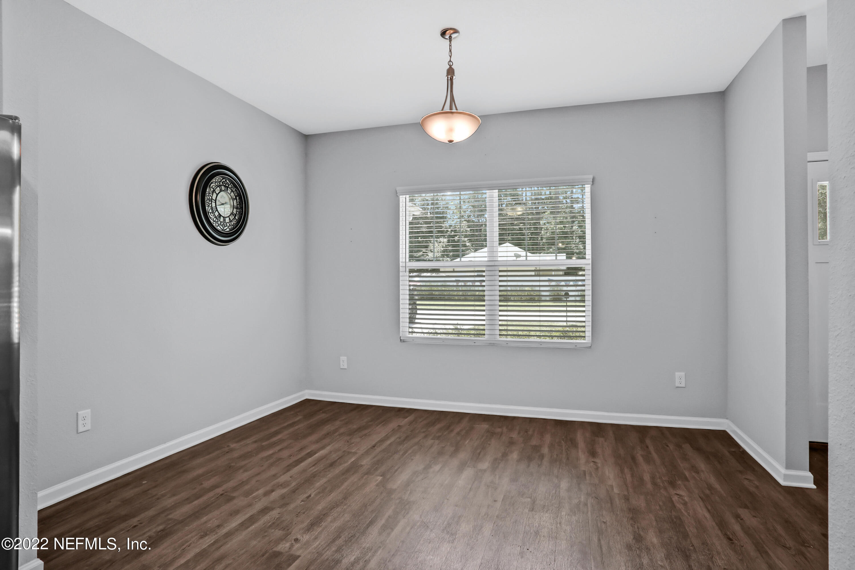 7507 Hilsdale Road Jacksonville, FL 32216 - Photo 12 of 38 a view of an empty room with wooden floor and a window