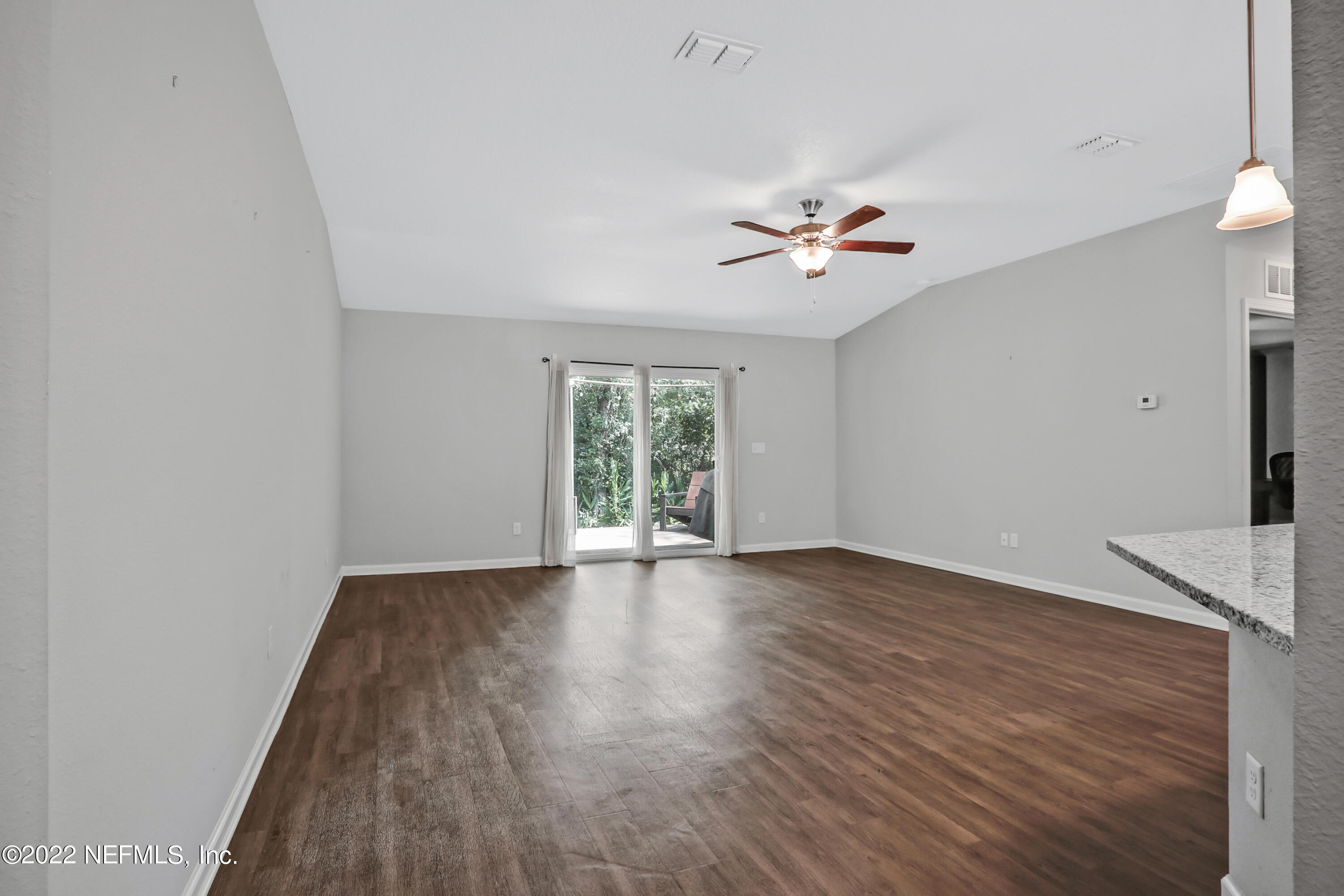 7507 Hilsdale Road Jacksonville, FL 32216 - Photo 15 of 38 an empty room with wooden floor and window