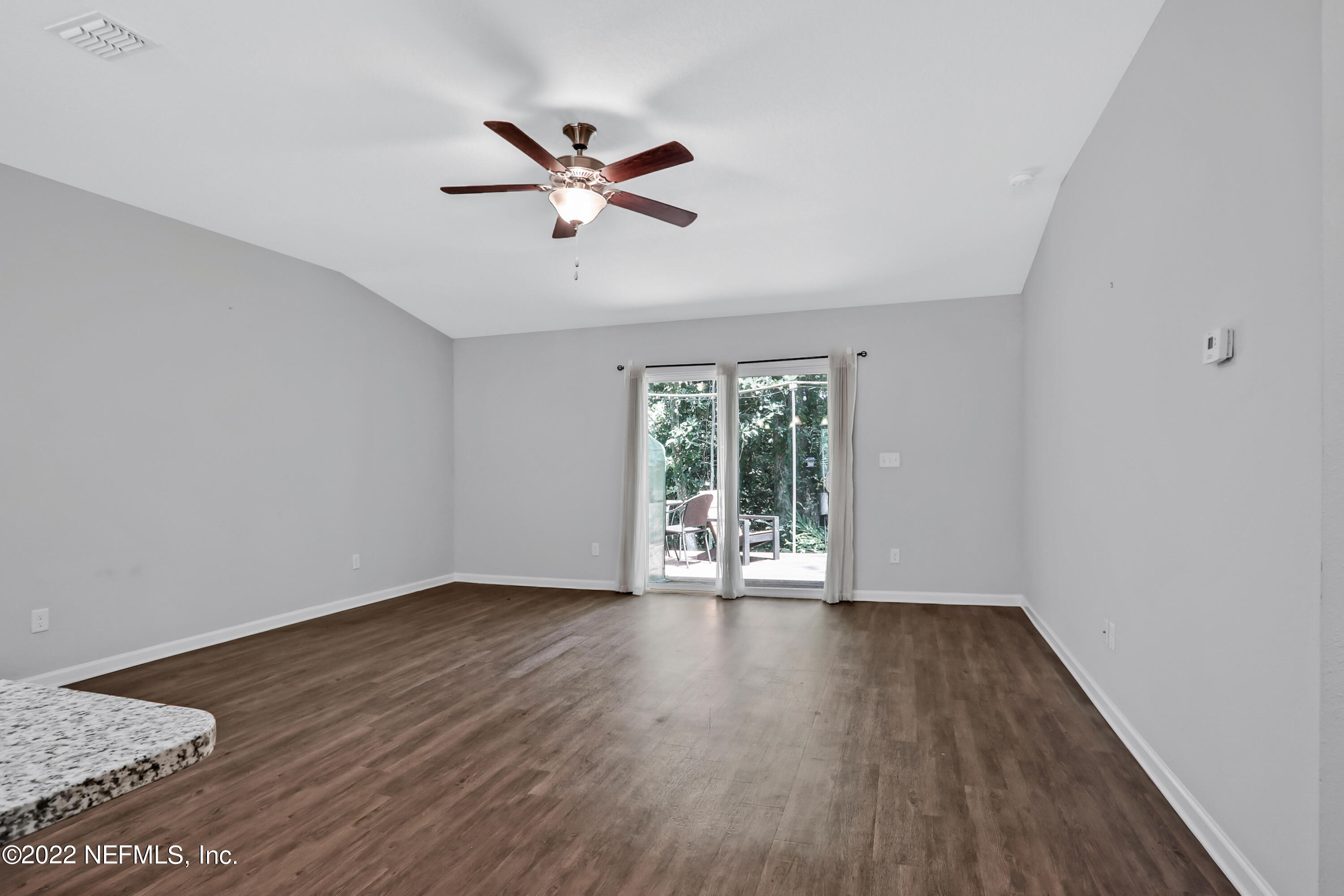 7507 Hilsdale Road Jacksonville, FL 32216 - Photo 16 of 38 a view of an empty room with wooden floor and a window