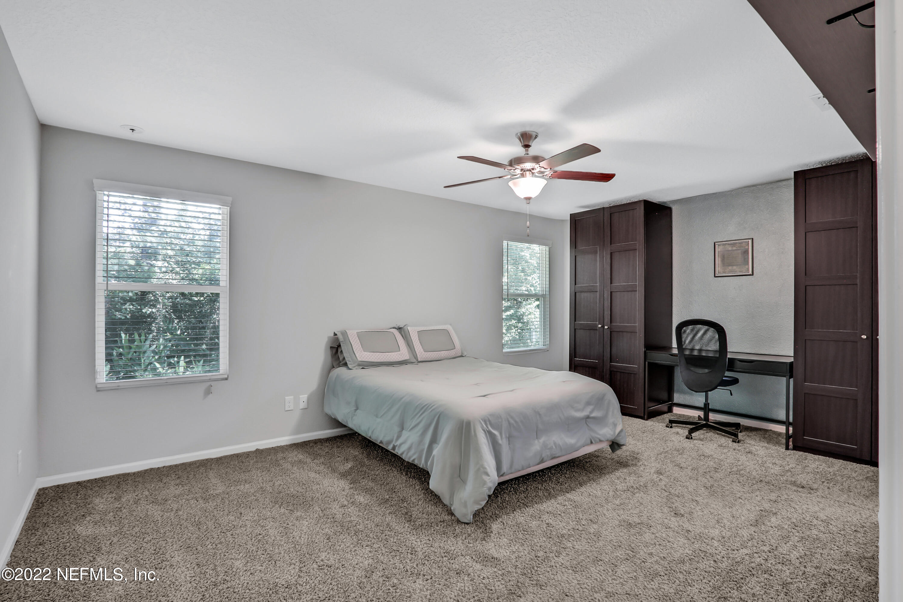 7507 Hilsdale Road Jacksonville, FL 32216 - Photo 17 of 38 a bedroom with a bed and a chandelier